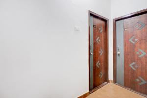 an empty room with a door and a corridor at Hotel O Rainbow in Warangal