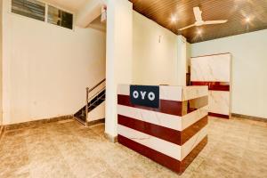an empty room with a sign on a wall at Hotel O Rainbow in Warangal