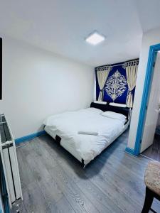 a bedroom with a bed with a blue and white headboard at Unique private rooms (1) in Bolton