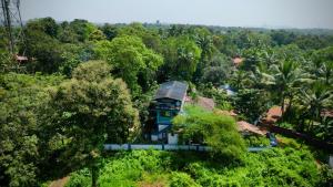 an aerial view of a house in the middle of a forest at Bela Blue Stays in Bardez +29 photos
