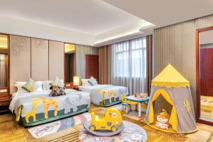 a bedroom with two beds and a play tent at Crowne Plaza Foshan by IHG in Foshan +193 photos