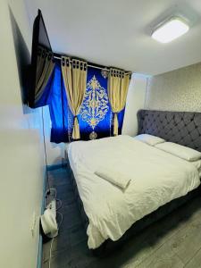 a bedroom with a bed with a blue and white at Unique private rooms (1) in Bolton