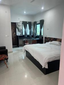 a bedroom with a large bed and a window at The Seven Suites - Fort View in Chittaurgarh