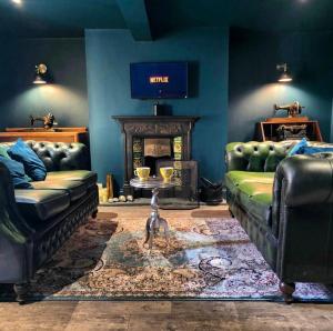 a living room with a couch and a fireplace at The Wolf's Den in Patrington