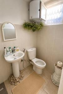 a bathroom with a toilet and a sink at La Terrazza in Tirana