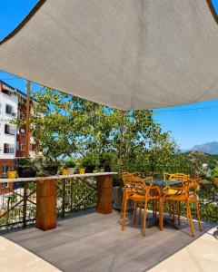 a patio with a table and chairs on a balcony at La Terrazza in Tirana
