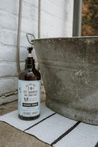 a bottle of oil sitting next to a metal bucket at The Beach House in West Wittering