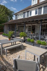 a group of picnic tables in front of a building at The Beach House in West Wittering
