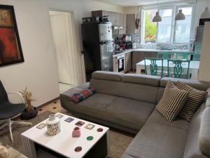 a living room with a couch and a table at Chez-Sonia chambre 1 in Rosny-sous-Bois