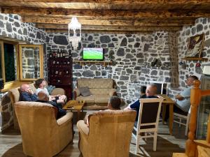 a group of people sitting in a living room at Nini Guesthouse Theth in Theth