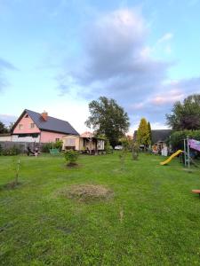 a yard with a house and a playground at Sky house in Jūrmala