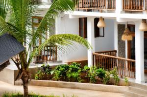 a palm tree in front of a building at The lagoons resort Zanzibar in Nungwi