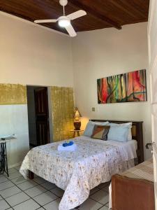 a bedroom with a bed and a ceiling fan at Pousada Bosque das Borboletas in Sabará +58 photos