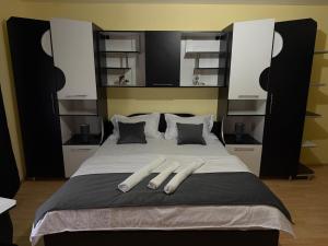 a bedroom with a large bed with white pillows at Casa David in Mălăeşti