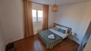 a small bedroom with a bed and a window at Chez Gabin in Tartas