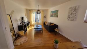 a living room with a couch and a table at Chez Gabin in Tartas