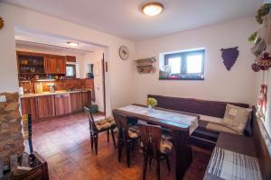 a living room with a wooden table and a couch at Sklípek Glosovi in Hovorany