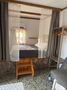 a bedroom with a bunk bed and a window at The traditional house-Skalia,kalymnos in Kalymnos