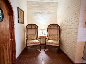 a hallway with two chairs and a table at Ocean Front Baja Vacation in Rosarito