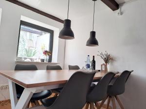 a dining room with a wooden table and chairs at Fischerstern in Maasholm