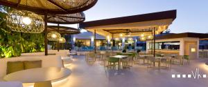 a restaurant with tables and chairs and lights at VH CostaBlanca - CARMEN in Teulada