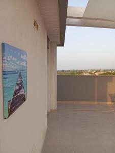 a picture of the ocean on the wall of a building at Villa Maldera-case vacanza-loft- loft queen specchio in Trani