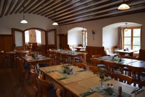 a dining room with wooden tables and chairs at Zum Schlosswirt in Fürsteneck