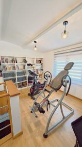 a gym with two exercise bikes in a room at A Casa de Moire in Arnois