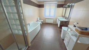 a bathroom with a tub and a toilet and a sink at A Casa de Moire in Arnois +19 photos