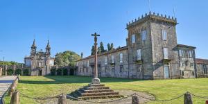 an old castle with a cross in front of it at A Casa de Moire in Arnois