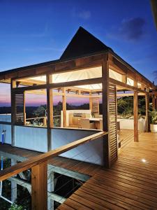 a house with a deck with a view at Aloha 28 in Ponta Mamoli