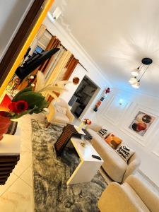 a living room with couches and a table at LyzHomes in Kampala