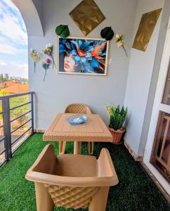 a balcony with a table and a table and a table at LyzHomes in Kampala