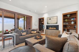 a living room with a couch and a fireplace at Rivers End Lake House in Bigfork