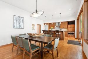 a kitchen and dining room with a wooden table and chairs at Rivers End Lake House in Bigfork