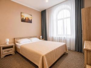 a hotel room with a bed and a window at Nika Apart hotel in Riga +12 photos