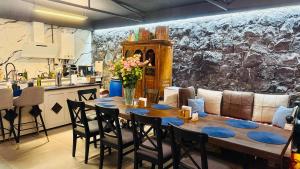 a table and chairs in a kitchen with a stone wall at Malishka Eco Villas in Malishka