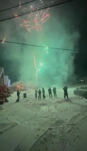 a group of people walking in the snow at night at Domki na Podgórzu in Duszniki Zdrój