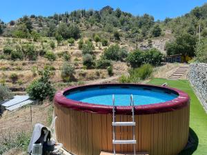 a large circular pool with a ladder in a yard at Safari House with fireplace in Agros