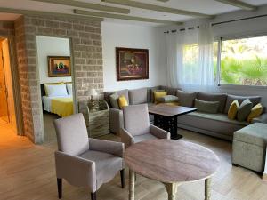 a living room with a couch and a bed at palmeraie4 in Skhirat