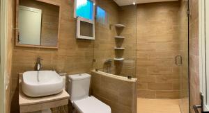 a bathroom with a toilet and a sink and a shower at palmeraie4 in Skhirat