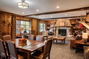 a living room with a wooden table and a fireplace at Ayres Lodge Alpine in Alpine