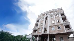 a tall white building with a sky in the background at Hotel MM prestige Raipur in Raipur