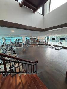 a gym with several treadmills and benches in a large room at Panbil Residence Apartment - Studio 2 Bed in Bagam +13 photos