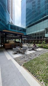 a group of benches in front of a building at Panbil Residence Apartment - Studio 2 Bed in Bagam