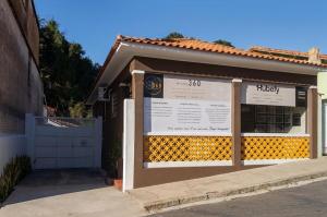 a building with a sign in front of it at Casa Estilo - São Lourenço in São Lourenço