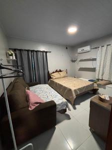 a living room with two beds and a couch at Casapalmares in Parintins