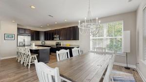 a kitchen and dining room with a table and chairs at Bethany Woods - 31600 Charleys Run in Bethany Beach