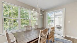 a dining room with a wooden table and chairs at Bethany Woods - 31600 Charleys Run in Bethany Beach +18 photos