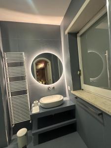 a bathroom with a sink and a mirror at Dimore Romano in Lecce